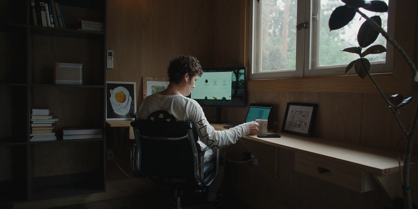 a man sitting at a desk in front of a computer