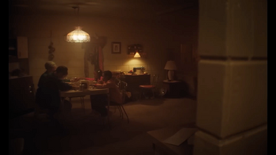 a group of people sitting at a table in a dark room