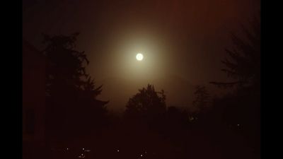 a full moon is seen in the dark sky