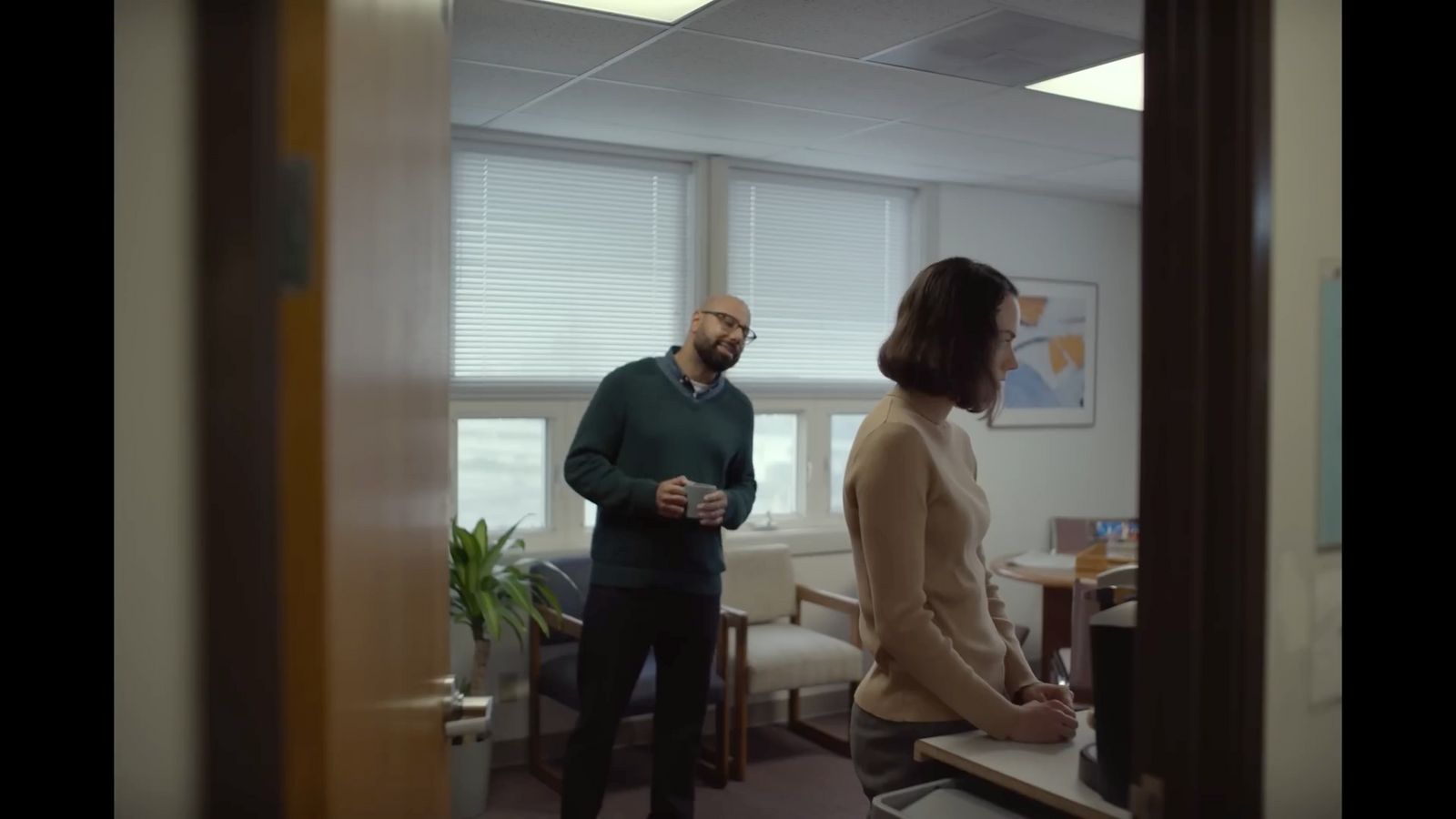 a man standing next to a woman in a room