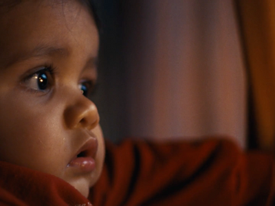 a close up of a child wearing a red shirt