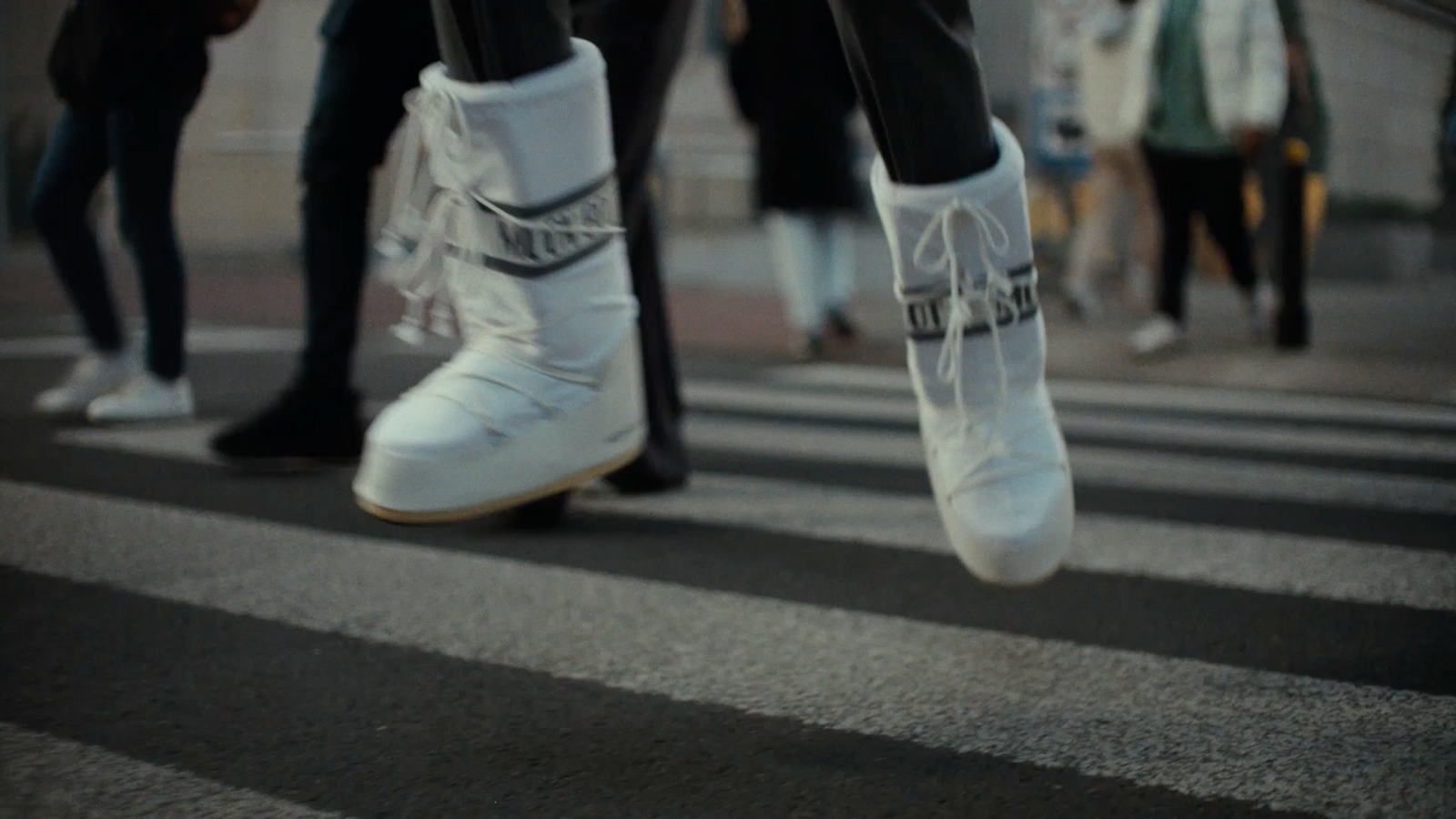 a group of people walking across a cross walk