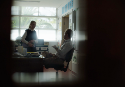 two people sitting at a desk in an office