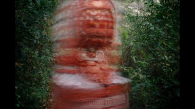 a blurry photo of a woman in a red dress