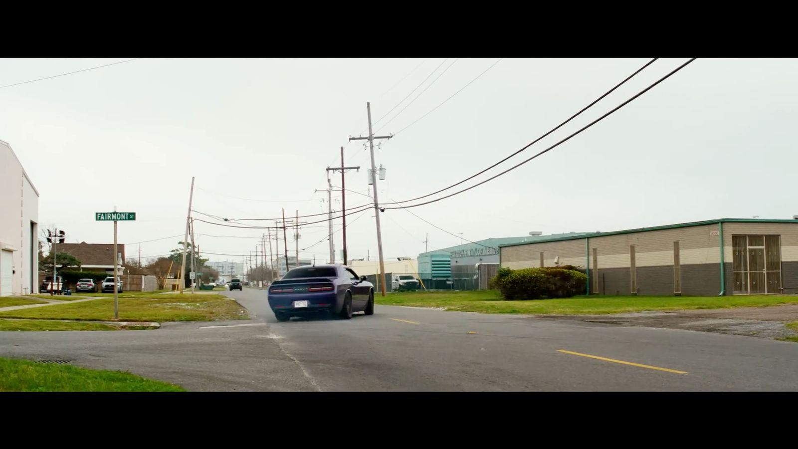 a car driving down a street next to a building