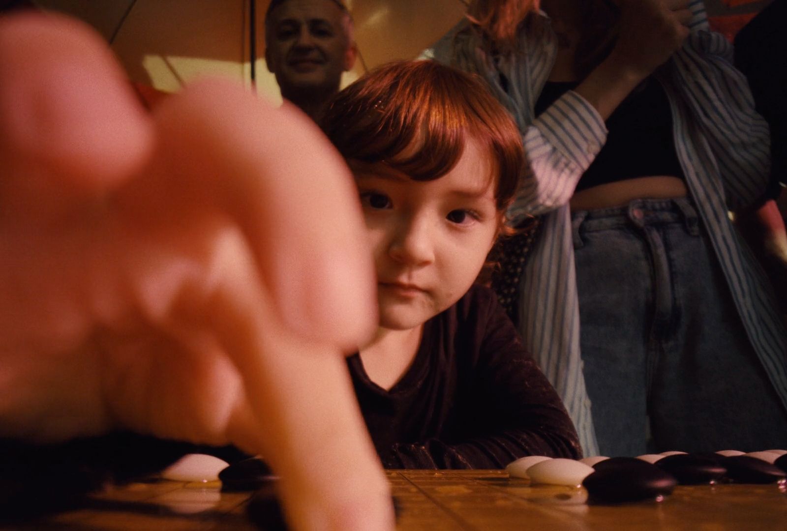 a little boy sitting at a table with a chocolate cake in front of him