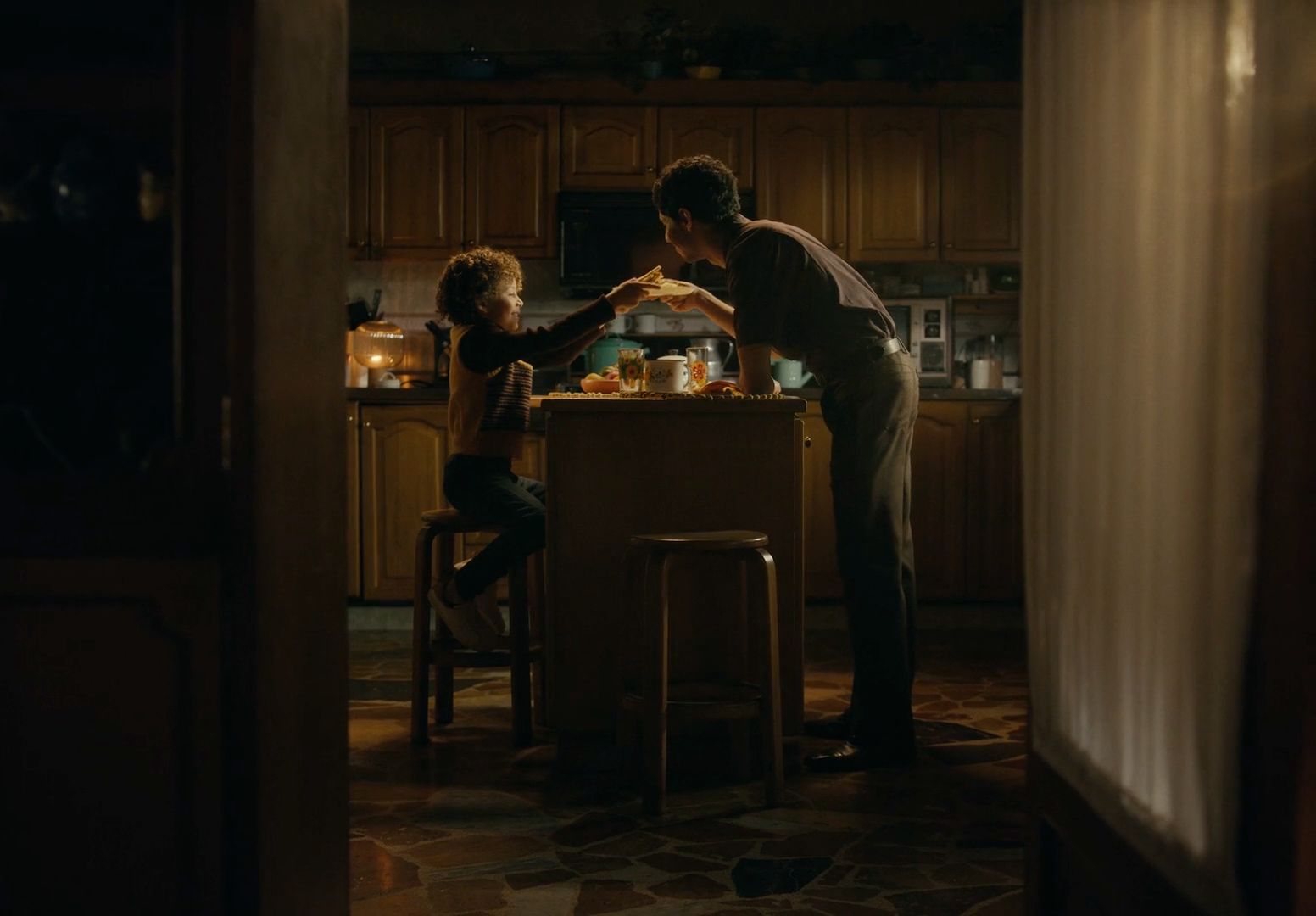 a man and a little girl standing in a kitchen