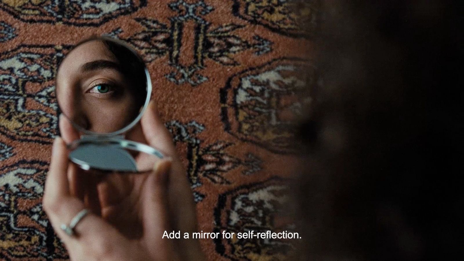 a person holding a mirror in front of their face