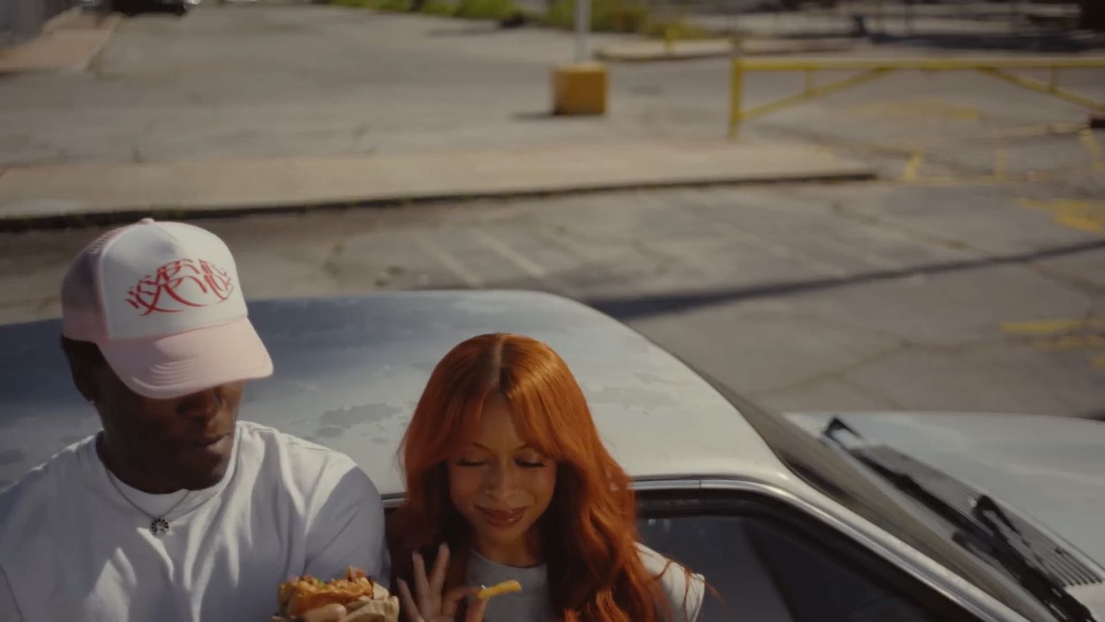 a man and a woman standing next to a car