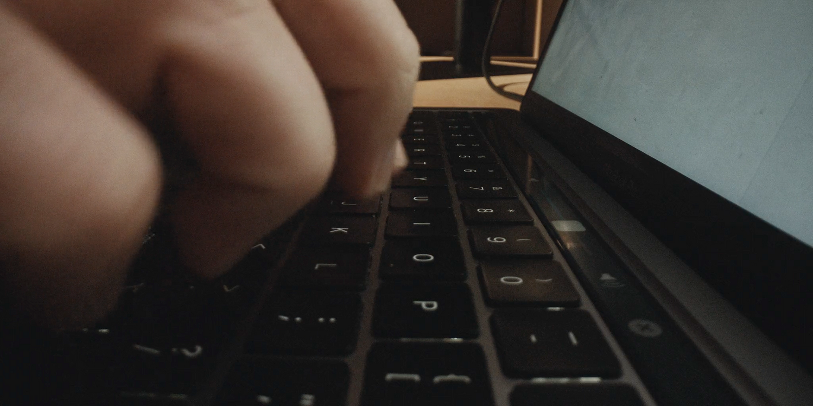 a close up of a person typing on a laptop