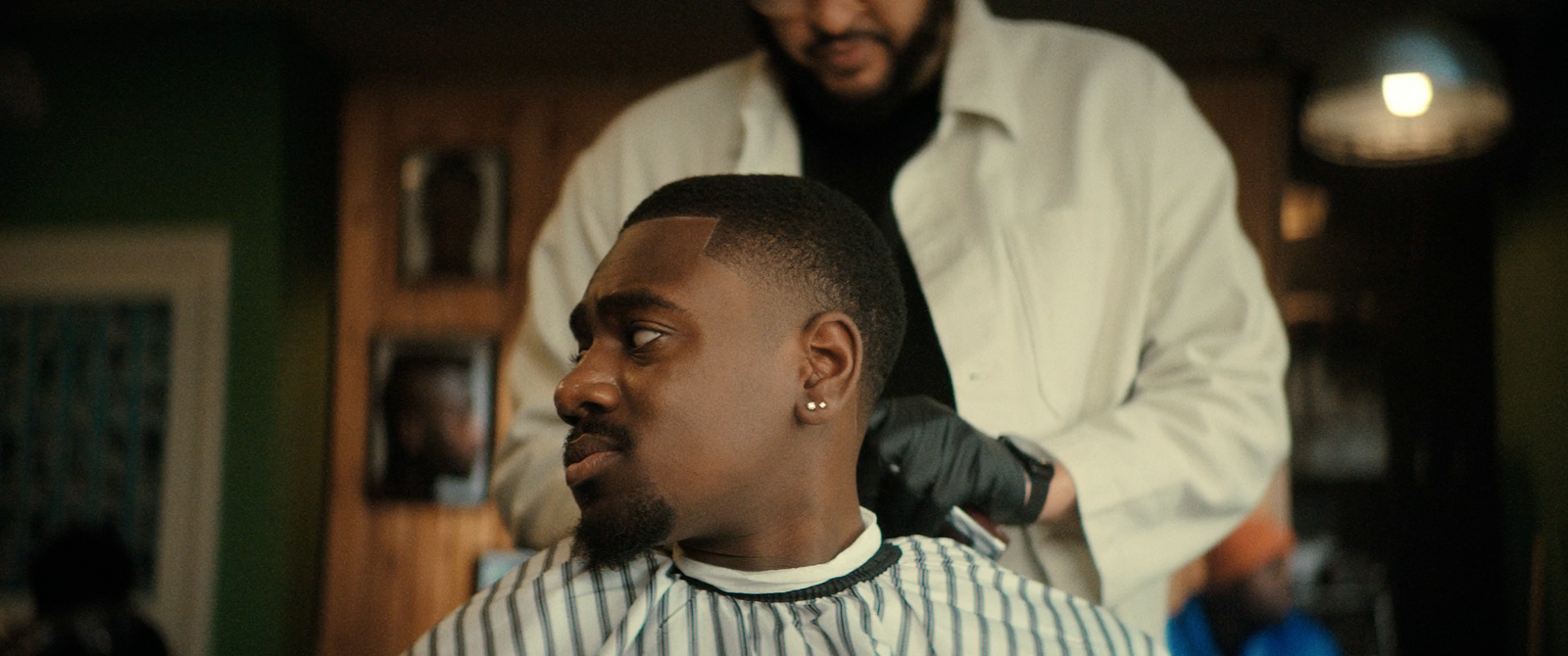 a man getting his hair cut by a barber