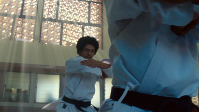 a man is practicing karate in a gym