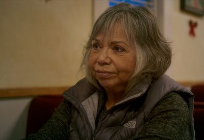 a woman sitting in a chair with her arms crossed