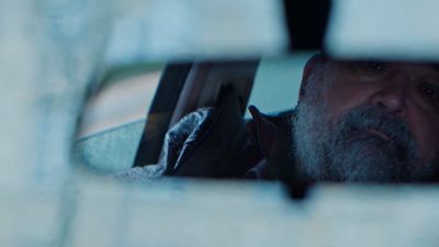 a man looking out the window of a car