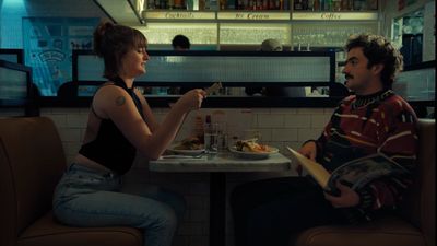 a man and a woman sitting at a table in a restaurant