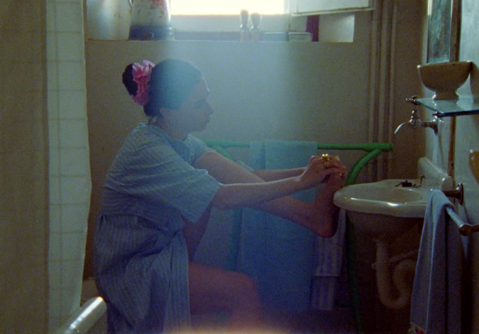 a woman sitting on a toilet in a bathroom