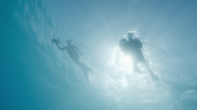 a couple of people are swimming in the water