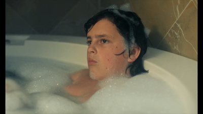 a woman in a bathtub with bubbles of water