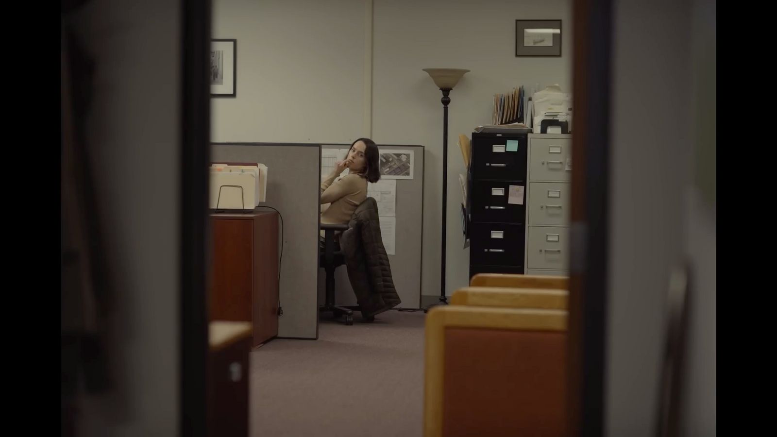 a woman sitting on a chair in an office