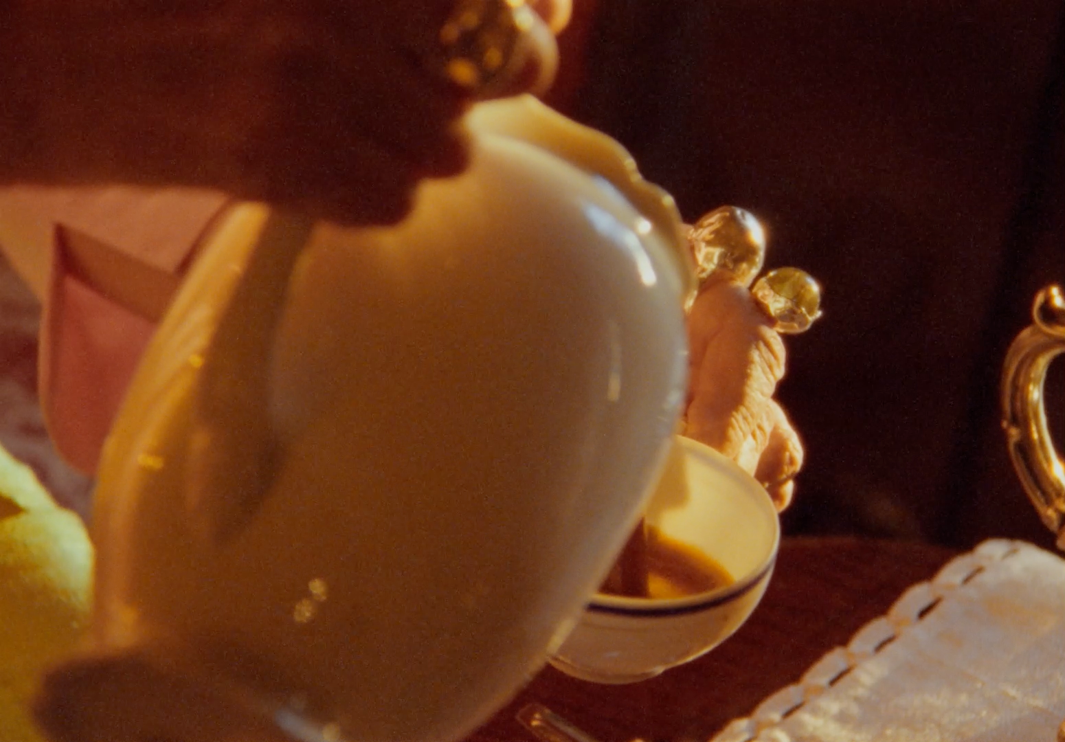 a close up of a person pouring liquid into a cup