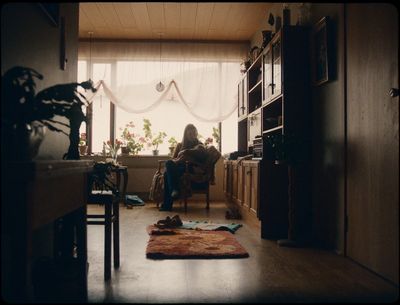 a woman sitting in a chair in a living room