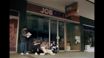 a group of people sitting outside of a job center