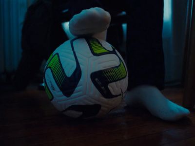 a soccer ball sitting on top of a wooden floor