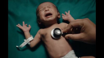 a baby being examined by a doctor with a stethoscope