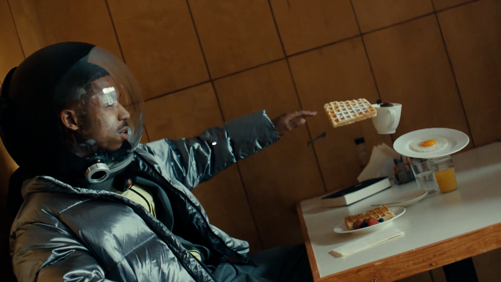 a man sitting at a table with a plate of food