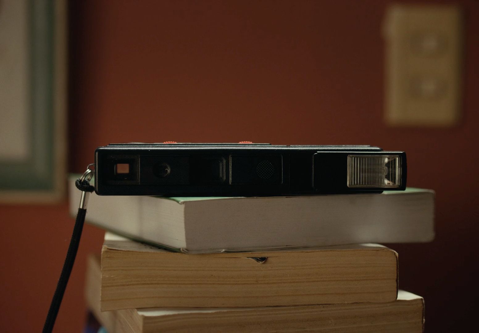 a camera sitting on top of a stack of books