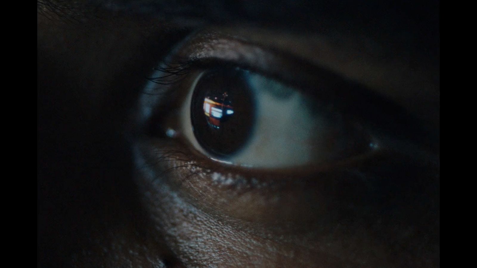 a close up of a person's eye in the dark