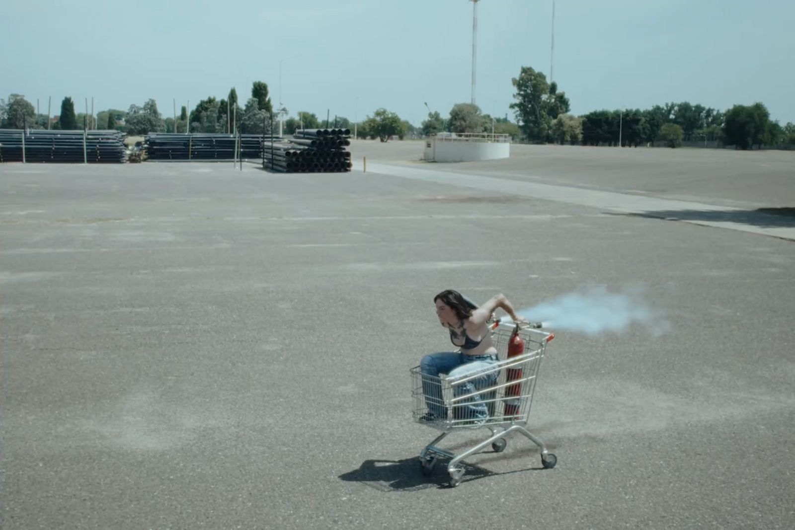 a woman sitting in a shopping cart smoking a cigarette