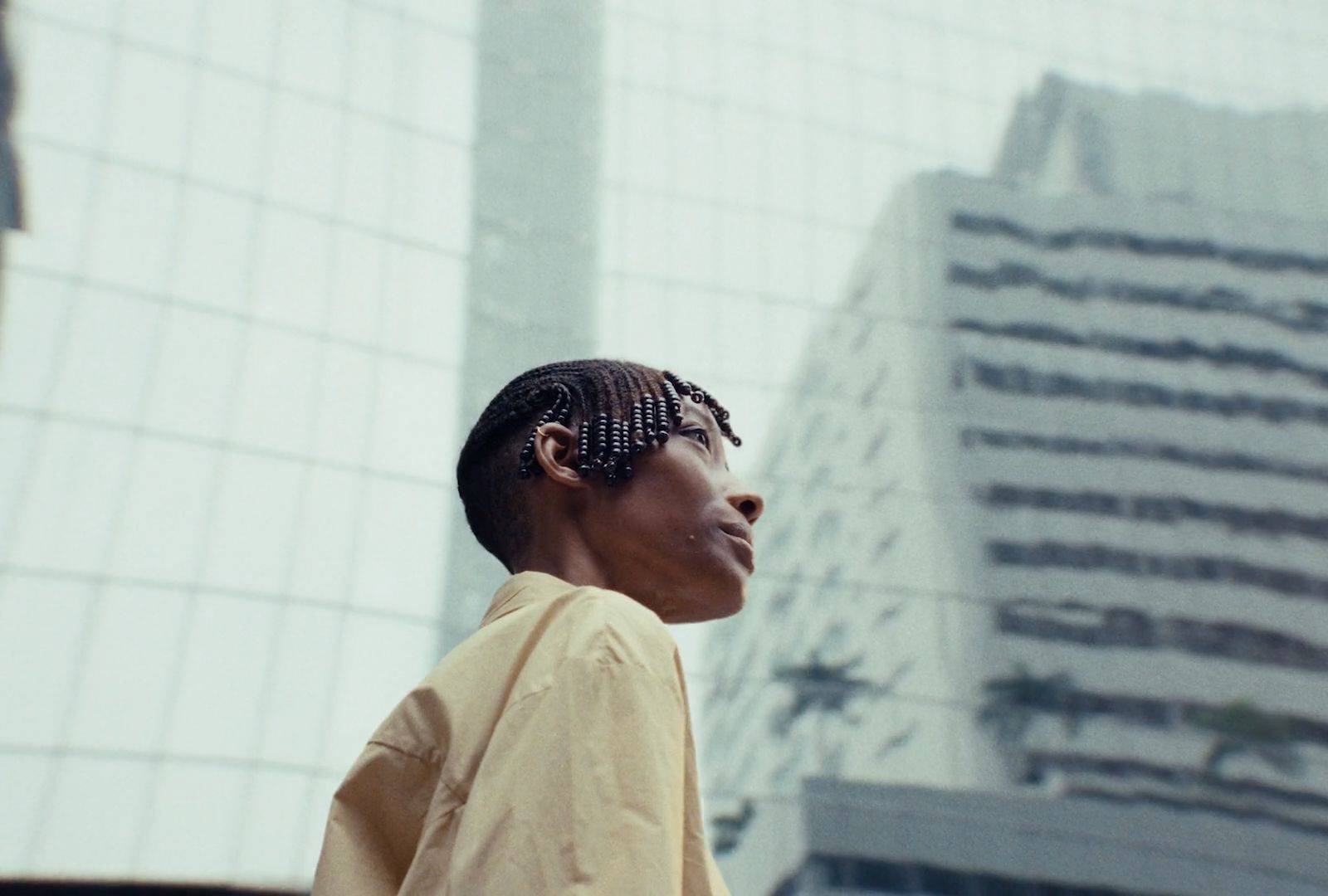 a woman standing in front of a tall building