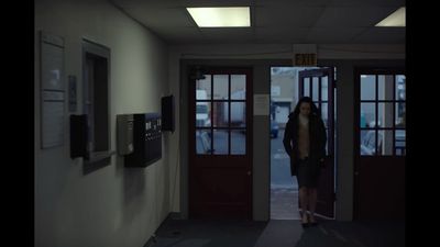 a woman standing in a doorway of a building