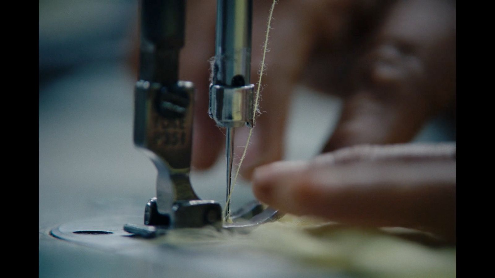 a close up of a person sewing on a sewing machine