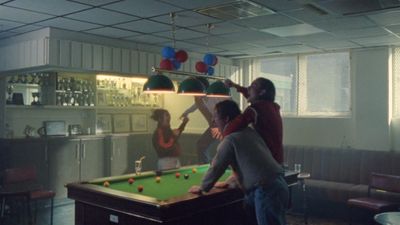 a group of people playing a game of pool