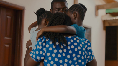 a group of people hugging each other in a room