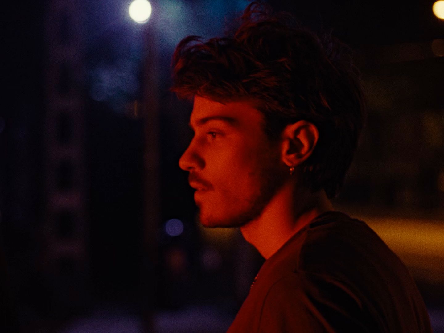 a man standing in the street at night