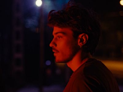 a man standing in the street at night