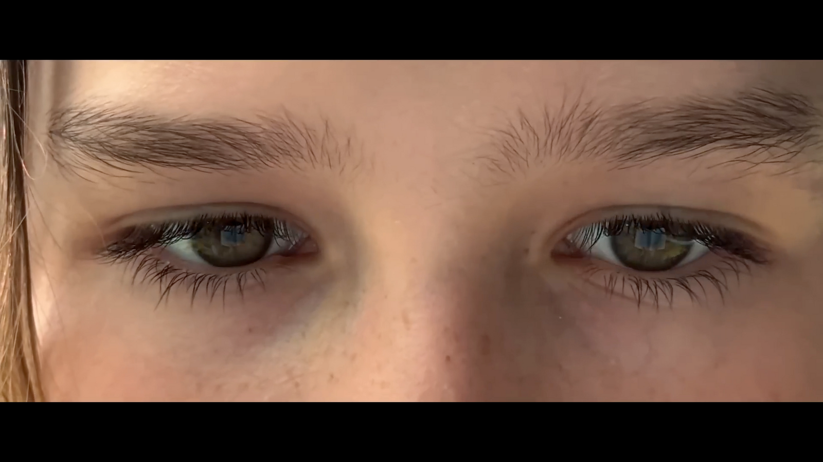 a close up of a person's blue eyes