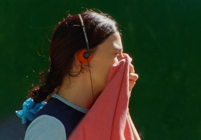 a woman covering her face with a towel