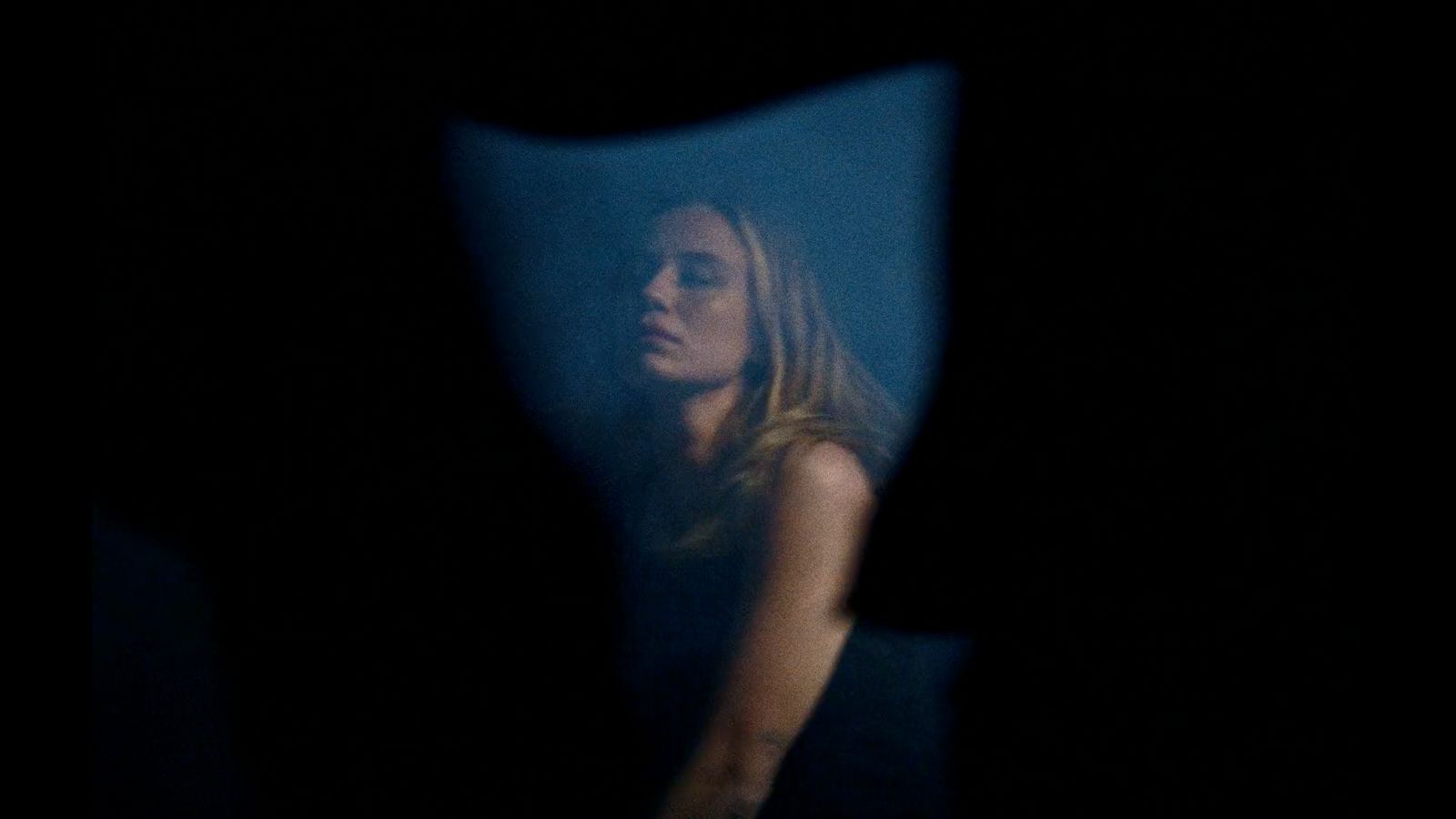 a blurry image of a woman in a dark room