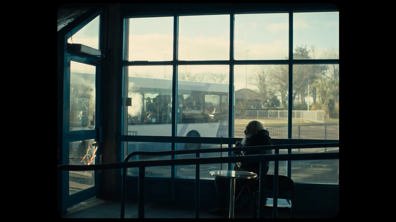 a woman sitting at a table in front of a window