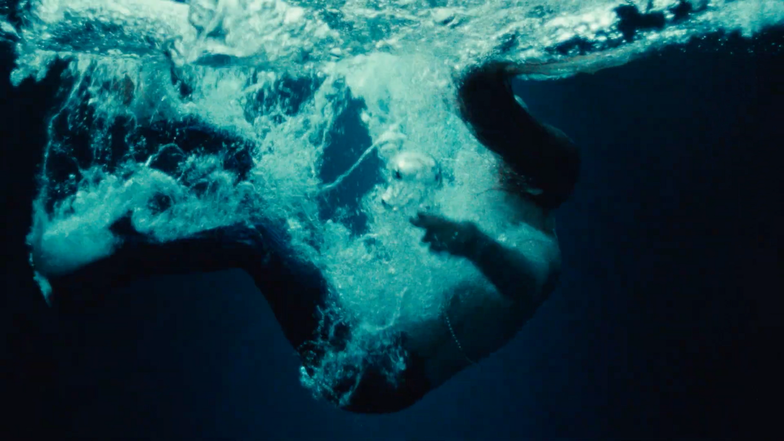 a woman's face is submerged in the water