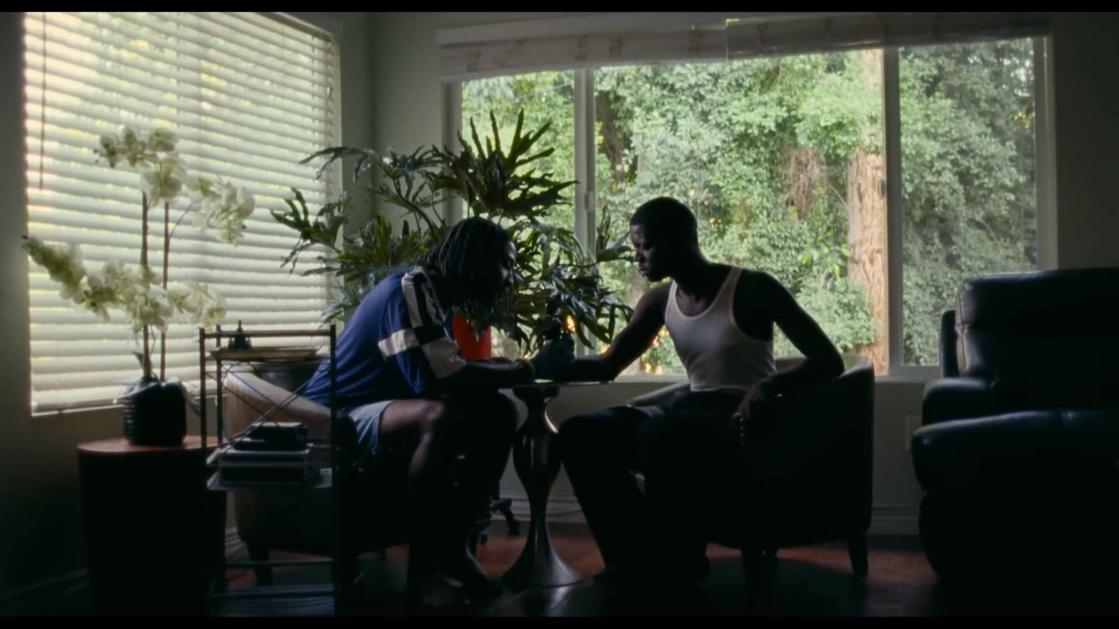 a couple of people sitting at a table in a room