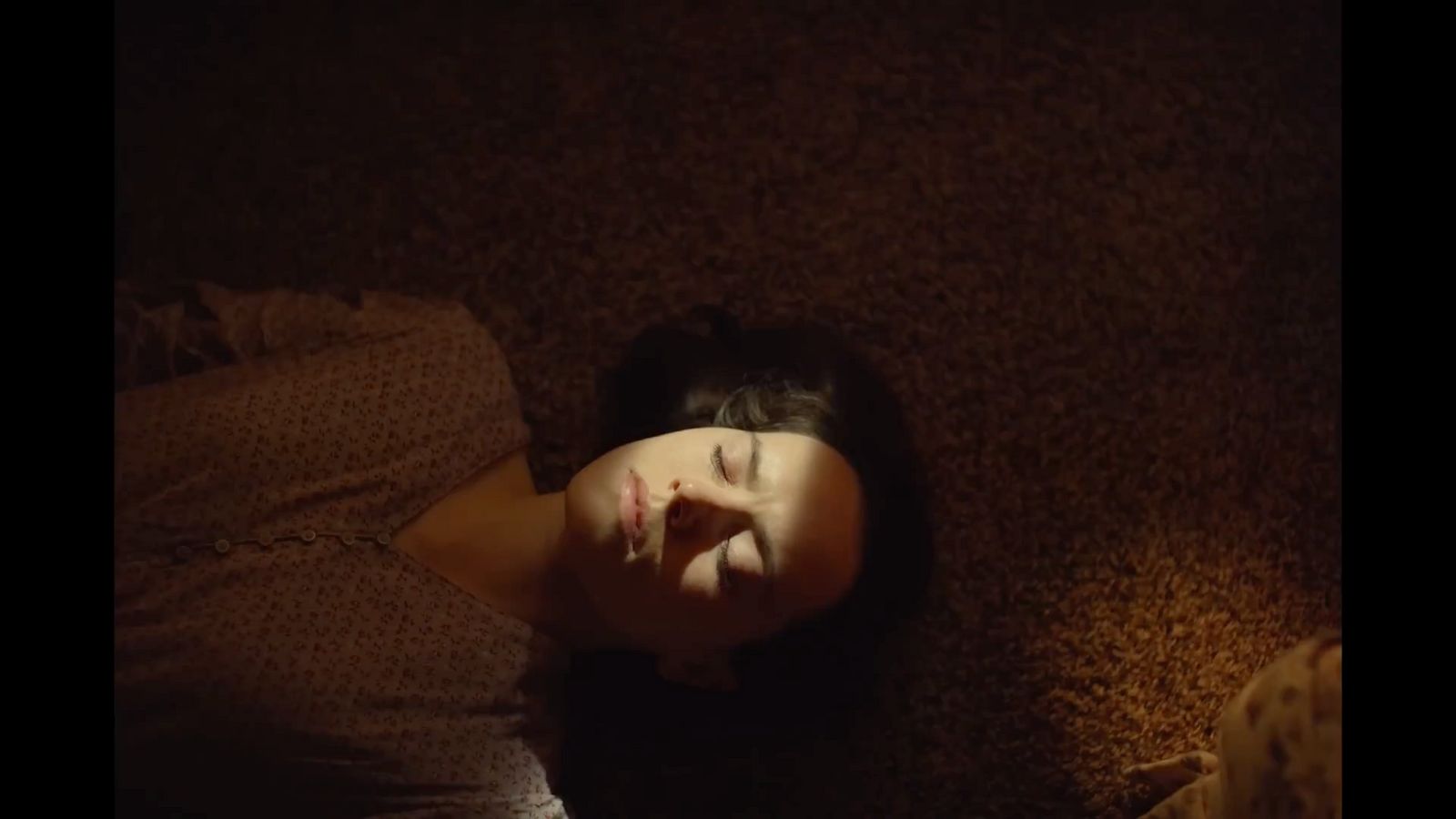 a woman laying on the floor with her eyes closed