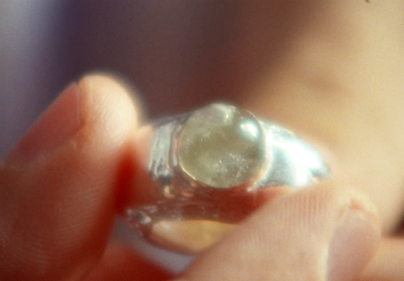 a close up of a person holding a ring