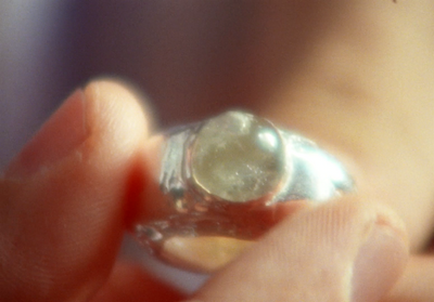 a close up of a person holding a ring