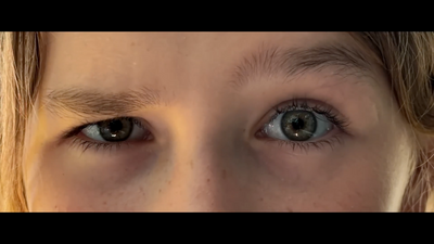 a close up of a child's blue eyes