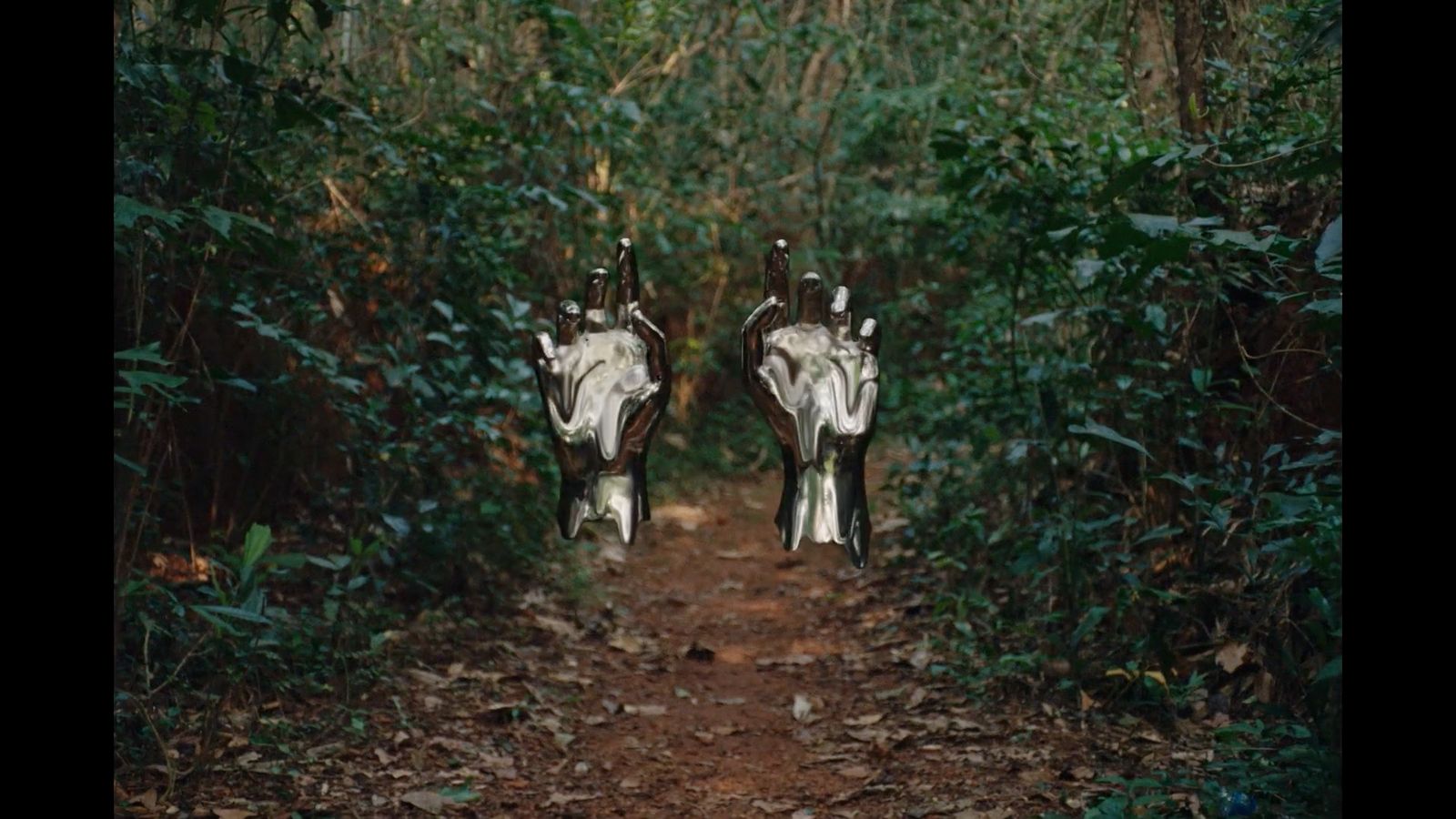 a couple of cows standing on top of a dirt road